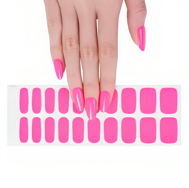 A hand with bright pink nails resting on a sheet of variously sized stick-on gel nail polish strips, against a white background.